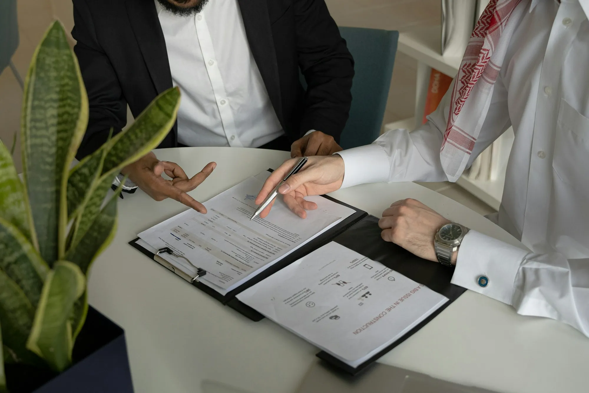 Two people reviewing documents on a clipboard